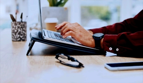 business email security office worker typing on laptop